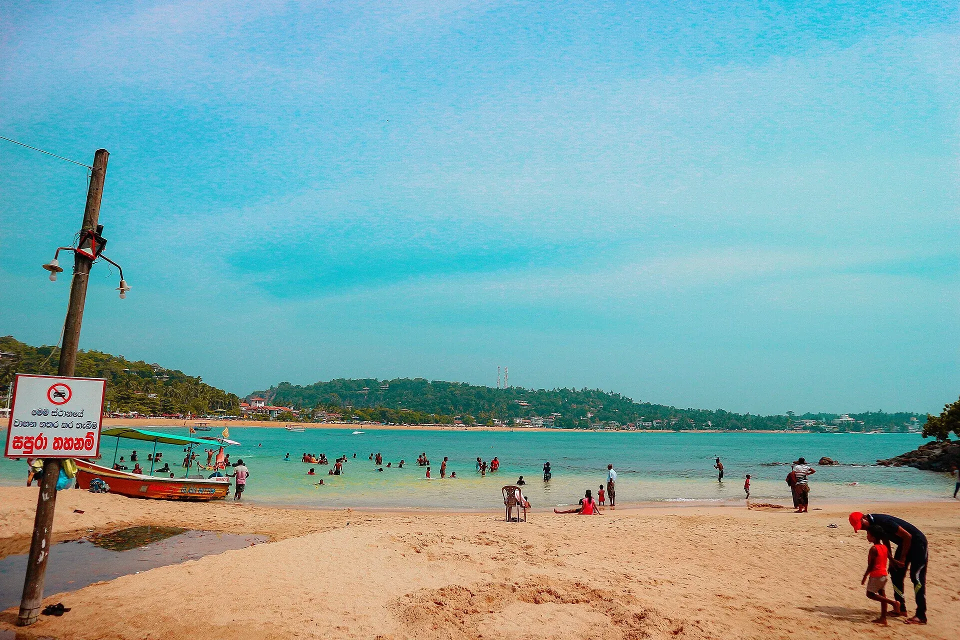 People enjoying Unawatuna beach and bay