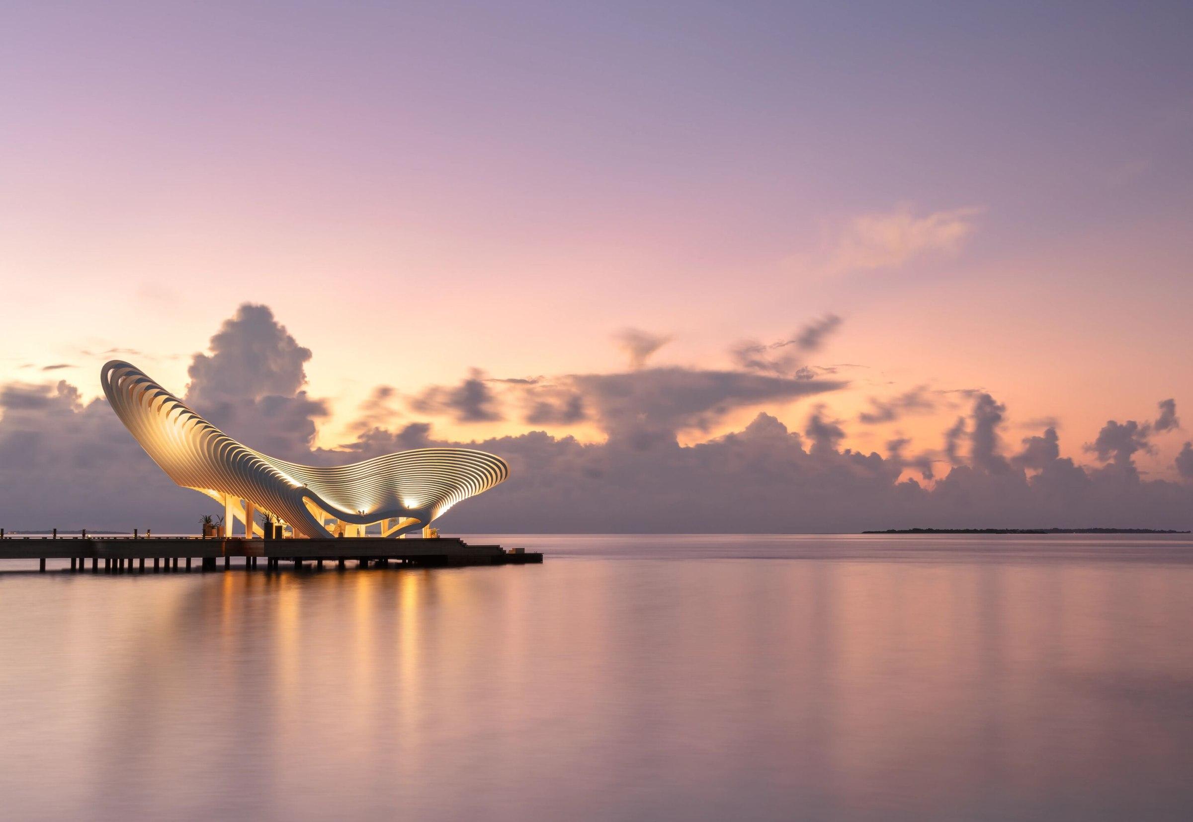 The Gate of Zero wellness pavilion over a still lagoon at dusk, JOALI BEING, Maldives