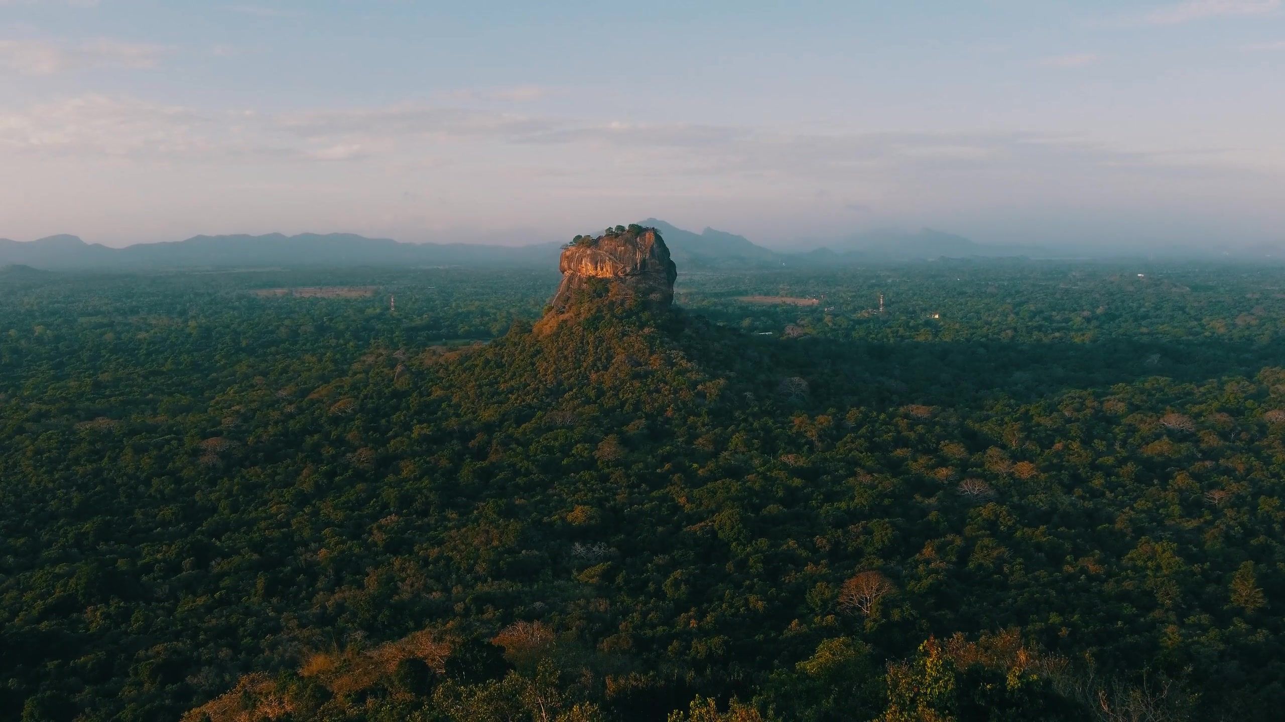 Aerial view of Sigiriya rock fortress rising from the surrounding jungle plain, central Sri Lanka.